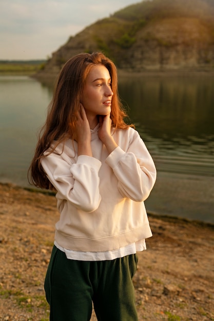 Side view smiley woman posing outdoors