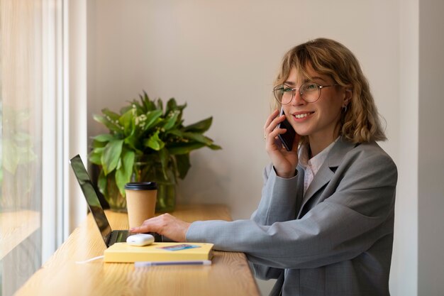 Side view smiley woman talking on phone