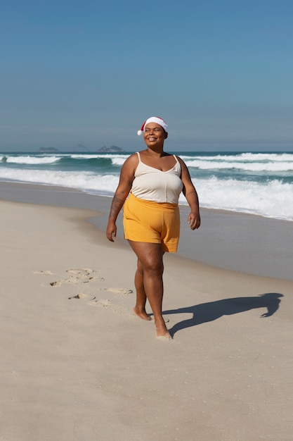 Side view smiley woman walking on beach