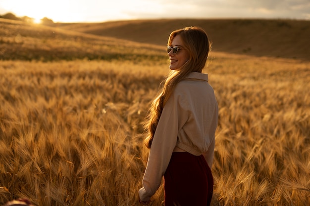 Side view smiley woman wearing sunglasses