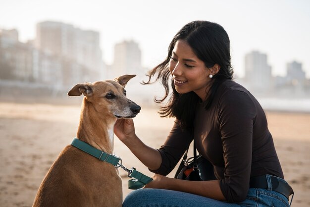 Side view smiley woman with cute dog