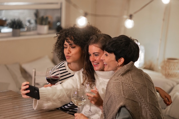 Side view smiley women taking selfie