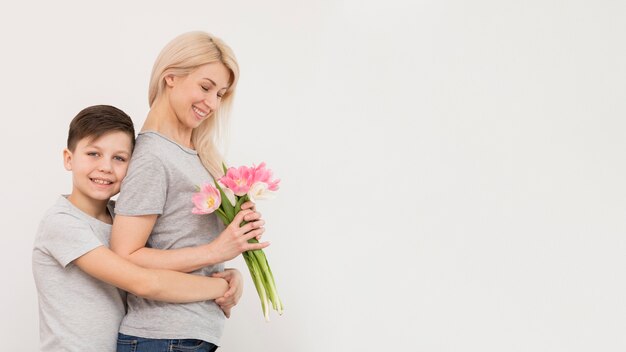 Side view son hugging his mother