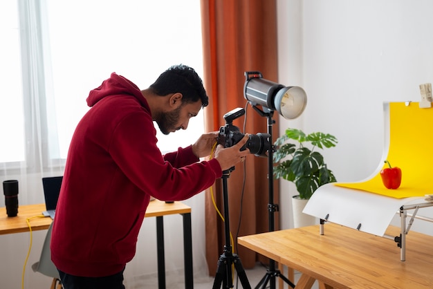 Side view specialized photographer working in studio