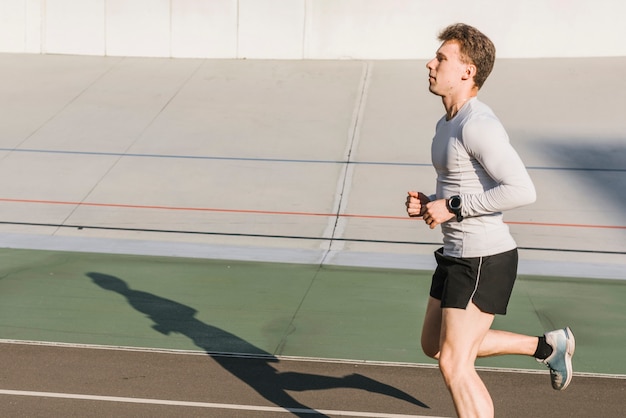 Side view of  sporty man running