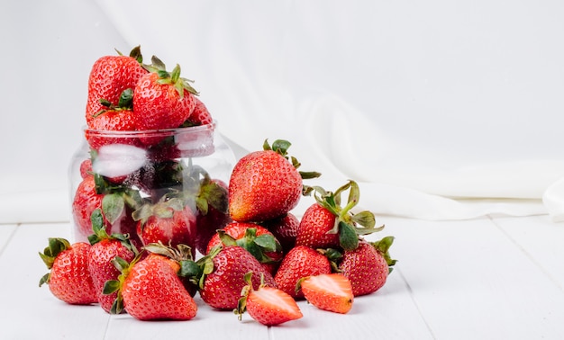 Side view strawberry in a jar on white background