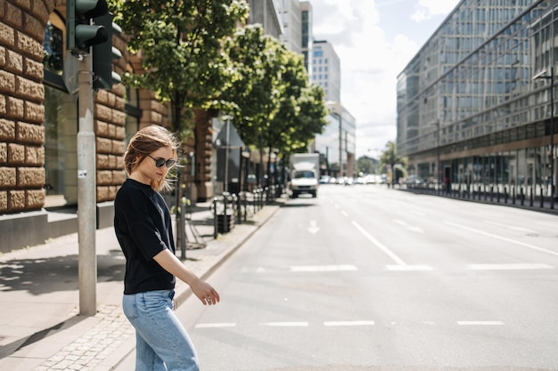 The side view of stylish woman walking on the street