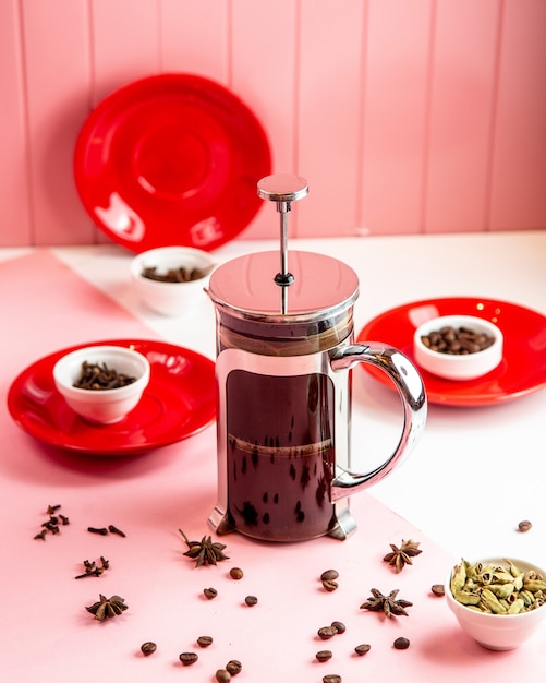 Side view teapot with coffee beans and tea herbs