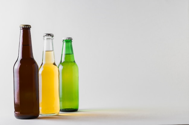 Free photo side view three different beers on table