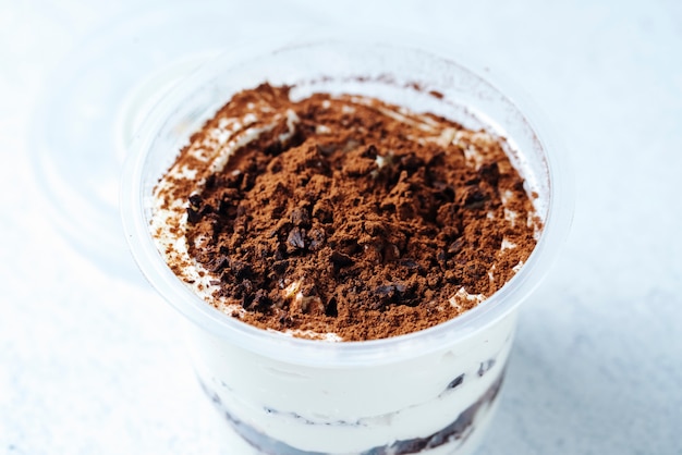 Side view tiramisu in a glass on a white background