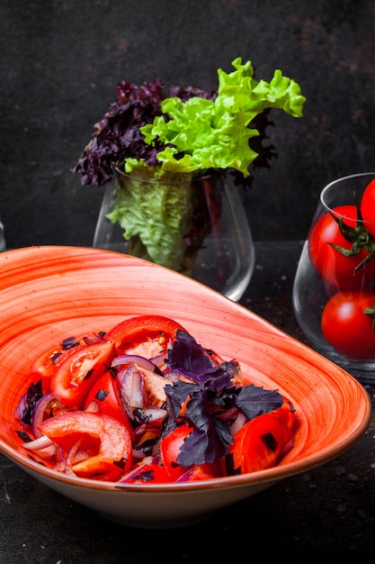 Free Photo side view tomato salad with onion and basil