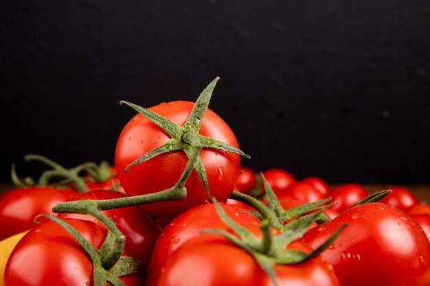 Side view of tomatoes on black background