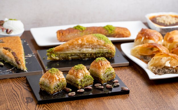 Side view of traditional turkish dessert baklava with pistachio on a wooden table