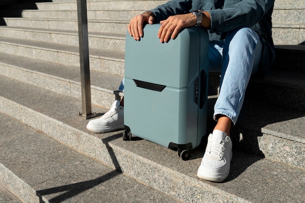 Free photo side view traveler with suitcase