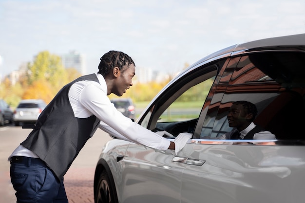 Side view valet talking to driver