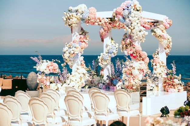 Free photo side view on wedding arch with flowers