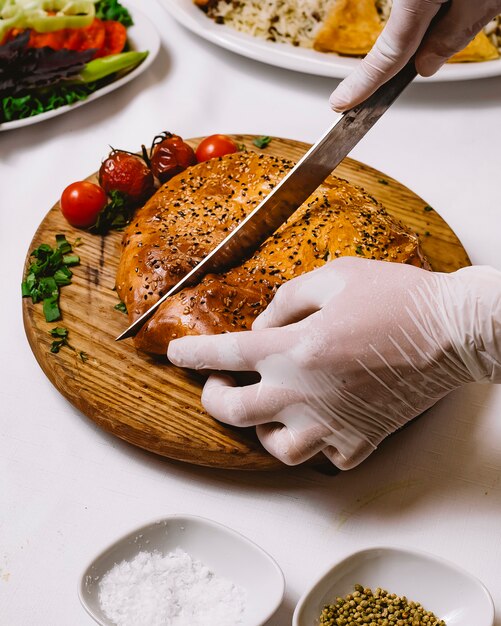 Side view wheat bread with tomato and spring onion on a board