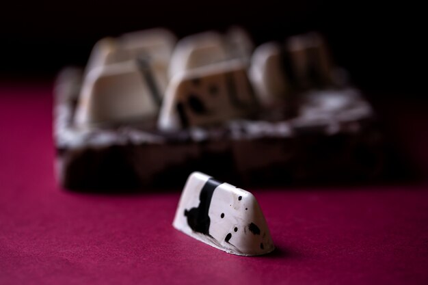 Side view white in black speck chocolate candy on the table