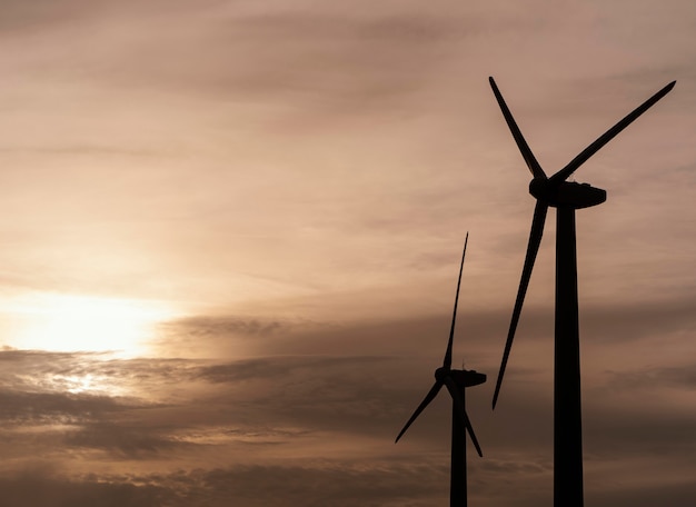 Side view of wind turbine silhouette generating electricity