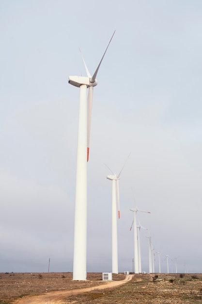 Free Photo side view of wind turbines in the field generating energy