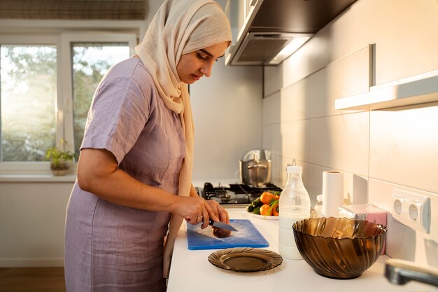 Side view woman cooking at home