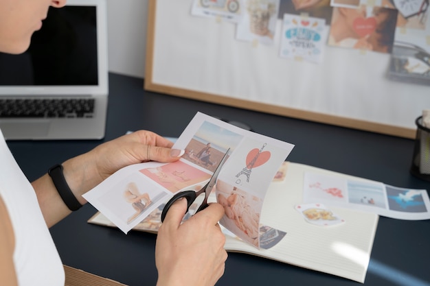 Free photo side view woman cutting paper