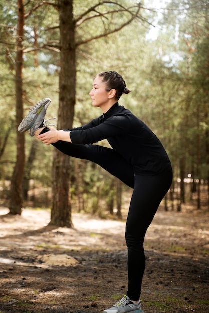 Side view woman doing sport outdoors