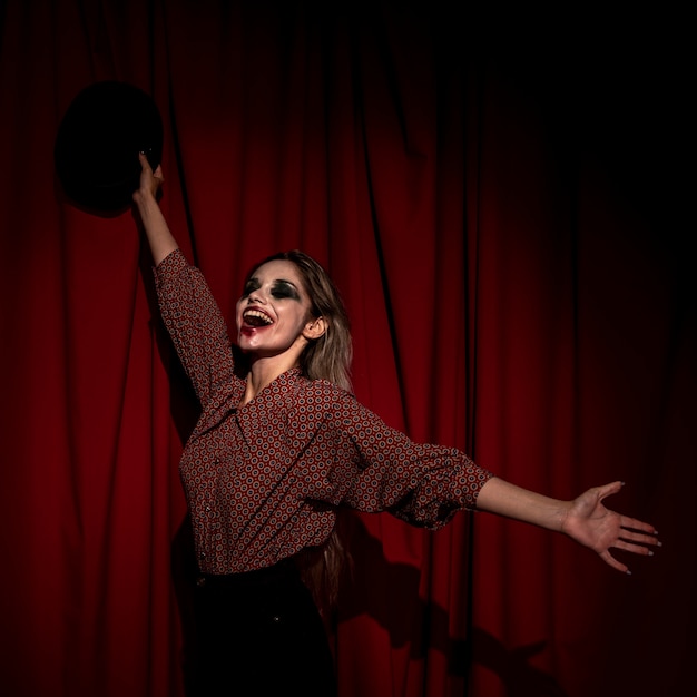 Free Photo side view woman dressed as a clown being happy