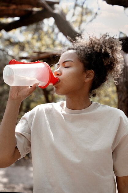 Side view woman drinking water