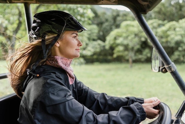 Free Photo side view woman driving jeep car