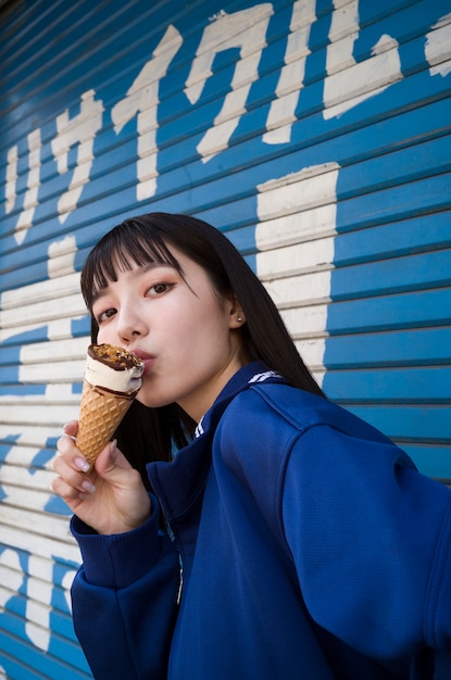 Free Photo side view woman eating ice cream