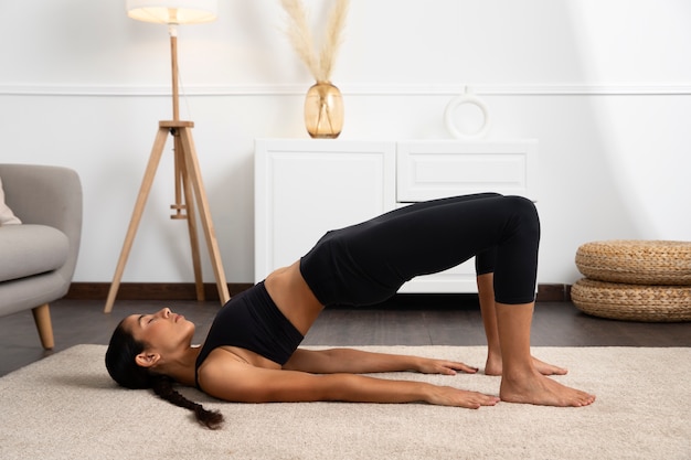 Side view  woman exercising at home