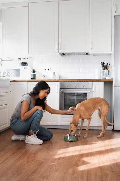 Side view woman feeding dog