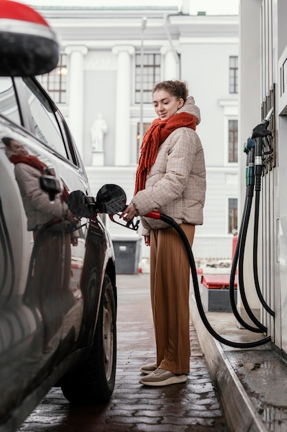 Side view woman at gas station