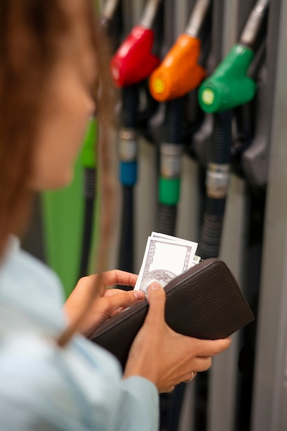 Free Photo side view woman at gas station