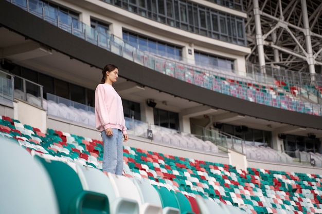 Free photo side view woman on grandstands