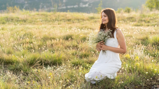 Side view of woman in the grass outside