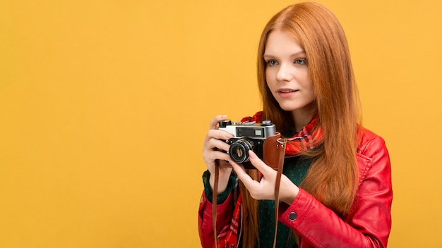 Free photo side view woman holding camera