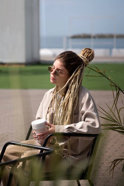 Side view woman holding coffee cup