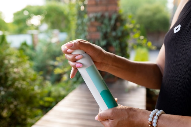 Free Photo side view woman holding dry shampoo