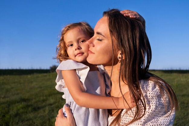 Side view woman holding girl