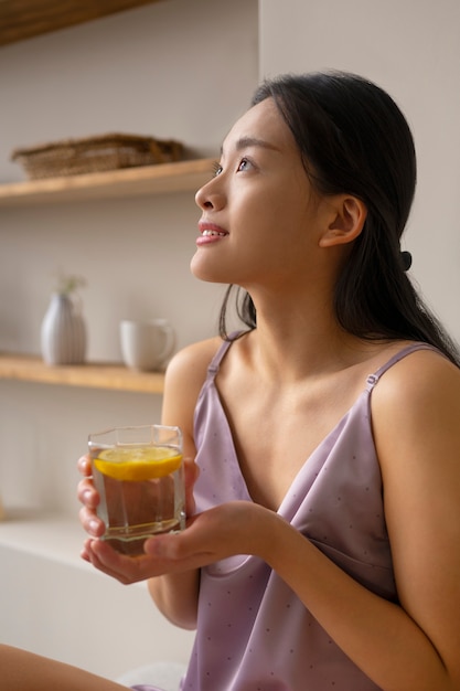 Side view woman holding healthy drink