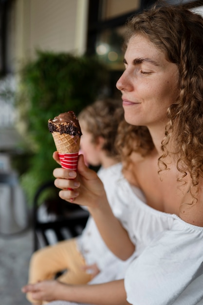 Free photo side view woman holding ice cream cone