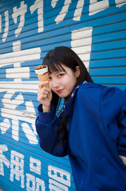 Free Photo side view woman holding ice cream cone