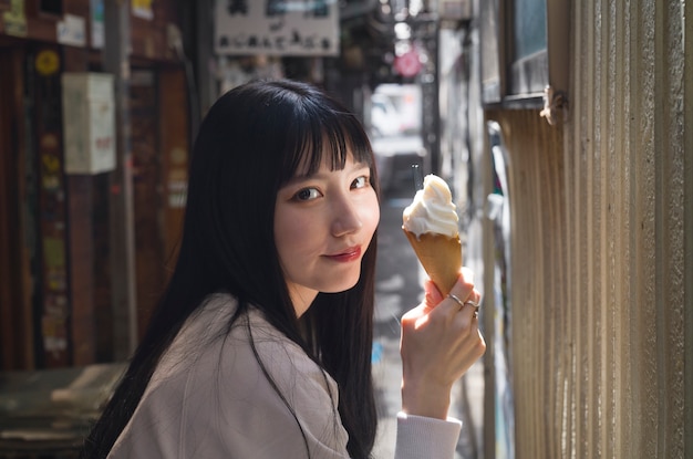 Side view woman holding ice cream cone