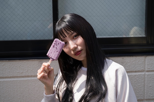 Side view woman holding ice cream