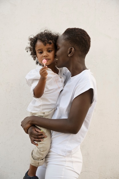 Side view woman holding kid