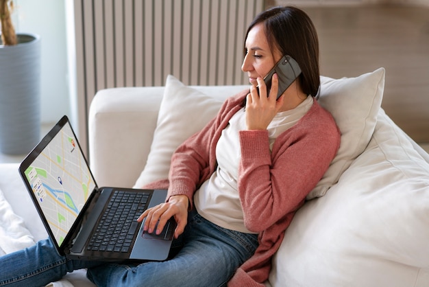 Free photo side view  woman holding laptop