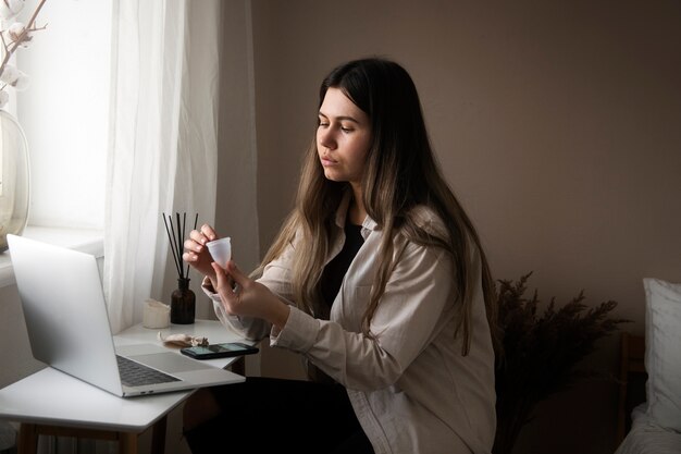 Side view woman holding menstrual cup