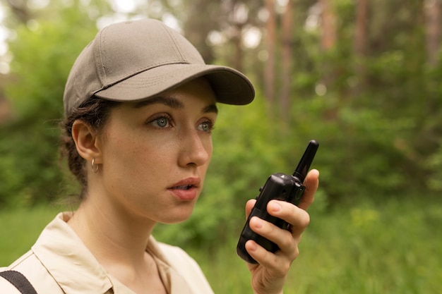 Side view woman holding walkie talkie